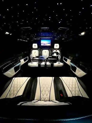 The full length of the cabin at night under the starlight headliner, lit by ambient door lighting